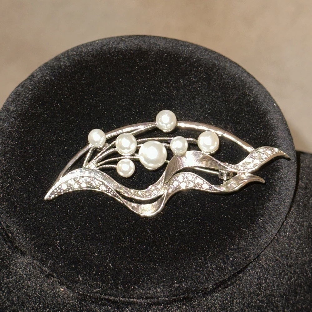 Silver and Pearl Brooch with versatile placement options. wavy design